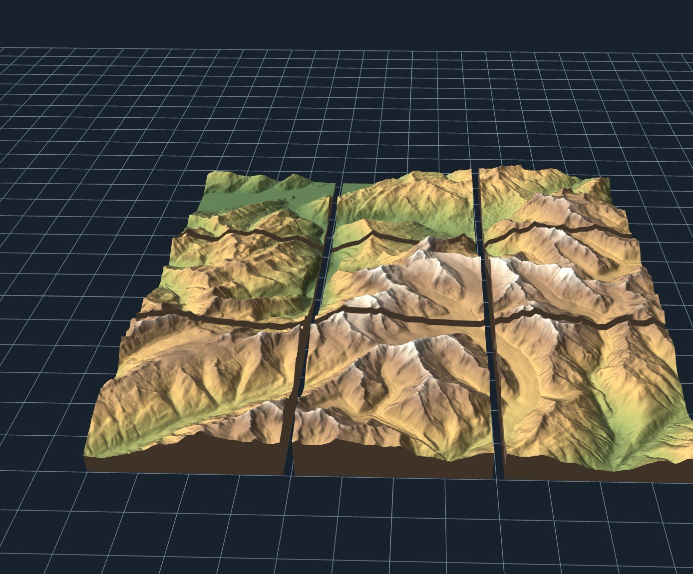 A large relief map of an alpine valley split into a three by three grid of separately printed tiles
